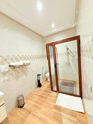 a bathroom with a shower with a glass door at Villa privée in Marrakech