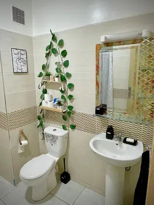 a bathroom with a toilet and a sink at Appartement cosy 2 min aéroport Marrakech 2 chambres bien équipé in Marrakech