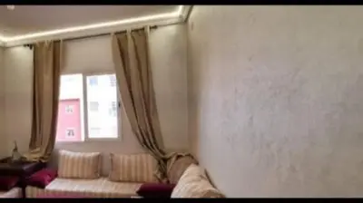 a living room with a couch and a window at Marrake Appartement familiale au centre de in Marrakech