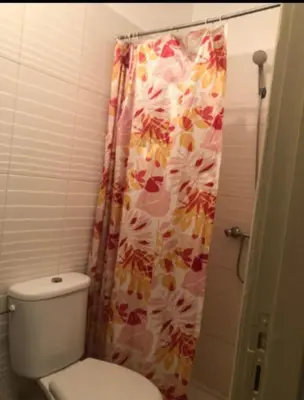 a bathroom with a toilet and a shower curtain at Marrake Appartement familiale au centre de in Marrakech