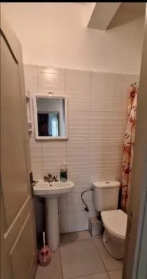 a small bathroom with a toilet and a sink at Marrake Appartement familiale au centre de in Marrakech