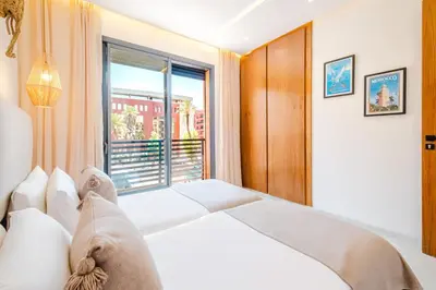 a bedroom with a bed and a large window at Modern and Cozy Apartment Center of Marrakech in Marrakech