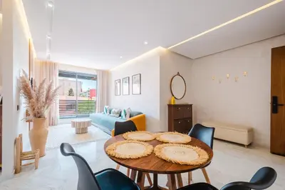 a living room with a table and chairs at Modern and Cozy Apartment Center of Marrakech in Marrakech