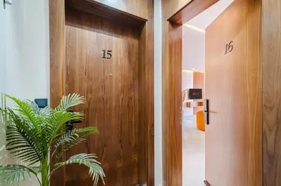 a wooden door in a room with a plant at Modern and Cozy Apartment Center of Marrakech in Marrakech