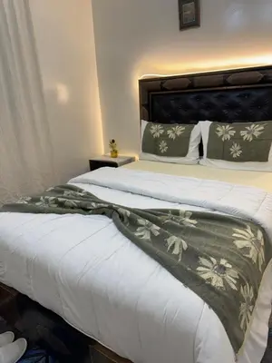 a bedroom with a bed with a blanket on it at Only 5-minutes walk to airport, your perfect choice for an early or late flight in Oulad Akkou