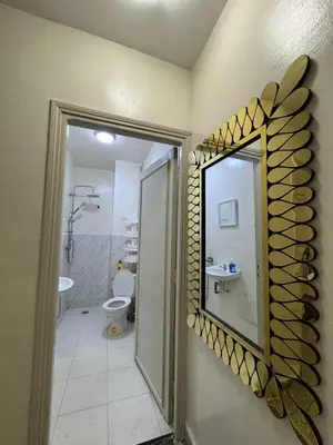 a bathroom with a mirror and a toilet at Only 5-minutes walk to airport, your perfect choice for an early or late flight in Oulad Akkou