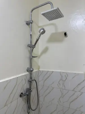 a shower in a bathroom with a shower head at Only 5-minutes walk to airport, your perfect choice for an early or late flight in Oulad Akkou