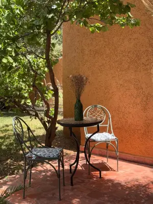 two chairs and a table with a vase on it at Villa Atlas Chill in Marrakech