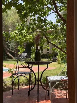 a table and two chairs with a vase on it at Villa Atlas Chill in Marrakech