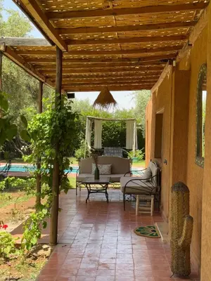an outdoor patio with a wooden pergola at Villa Atlas Chill in Marrakech