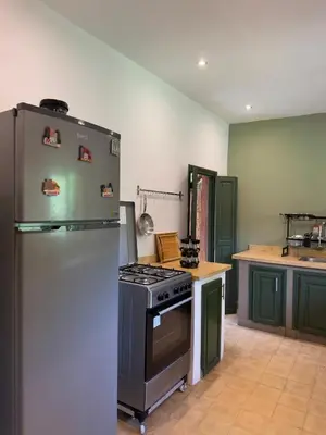 a kitchen with a refrigerator and a stove at Villa Atlas Chill in Marrakech