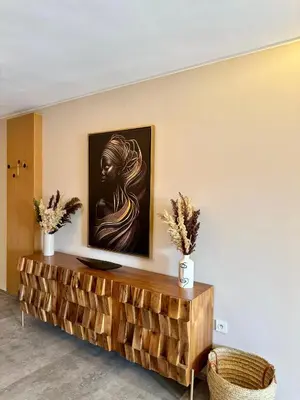 a living room with a painting of a woman on the wall at Lovely 2 bedroom apartment in Marrakech