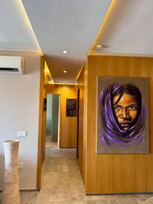 a painting of a woman on a wall in a hallway at Lovely 2 bedroom apartment in Marrakech