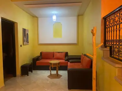 a living room with a couch and a table at Duplex Village in Marrakech