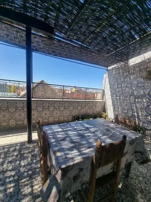 a table and chairs in a patio with a view at amazing home and amazing rooftop in Marrakech