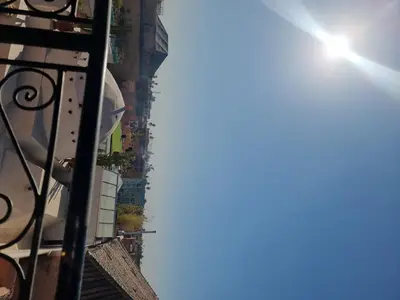 a view of a building with the sun in the sky at amazing home and amazing rooftop in Marrakech