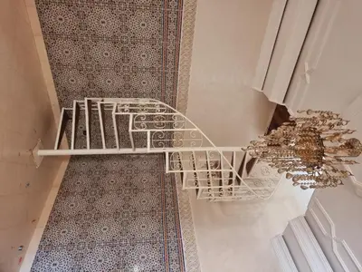 a staircase in a room with a chandelier at amazing home and amazing rooftop in Marrakech