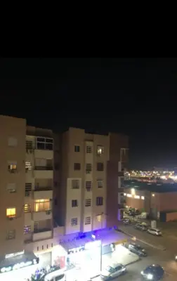 a view of a building at night with a parking lot at Appartement avec bel vue au centre de Marrakech in Marrakech