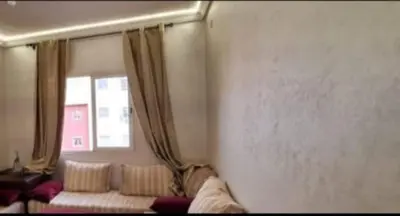 a living room with a couch and a window at Appartement avec bel vue au centre de Marrakech in Marrakech