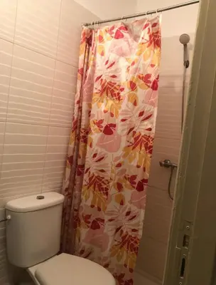 a bathroom with a toilet and a shower curtain at Appartement avec bel vue au centre de Marrakech in Marrakech