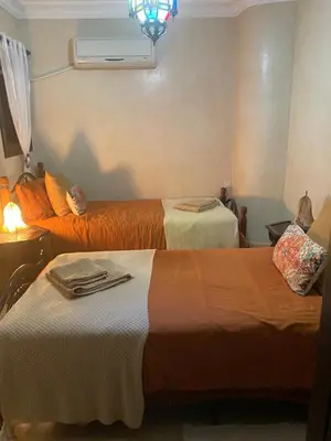 a room with two beds and a heater at Le Riad l'étoile beldi in Marrakech