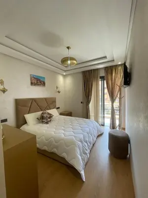 a bedroom with a large white bed and a window at Apartment for rent in Marrakech