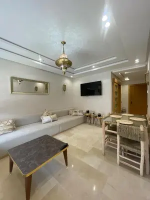 a living room with a couch and a table at Apartment for rent in Marrakech