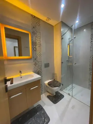 a bathroom with a toilet and a sink and a shower at Apartment for rent in Marrakech