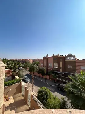 a view from a balcony of a street with buildings at Villa moderne avec jacuzzi & jardin - Marrakech in Marrakech