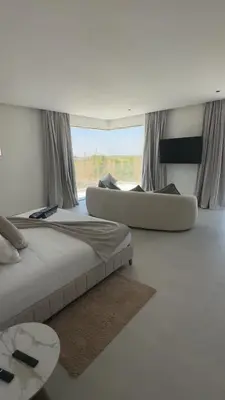a bedroom with two beds and a large window at Villa Selma in Marrakech