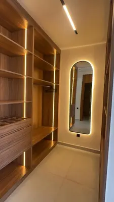 a dressing room with wooden shelves and a mirror at Villa Selma in Marrakech