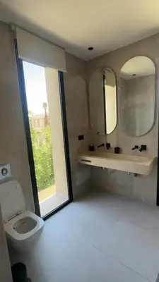 a bathroom with a toilet and a mirror at Villa Selma in Marrakech