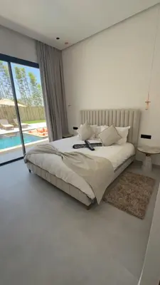 a bedroom with a large bed and a large window at Villa Selma in Marrakech