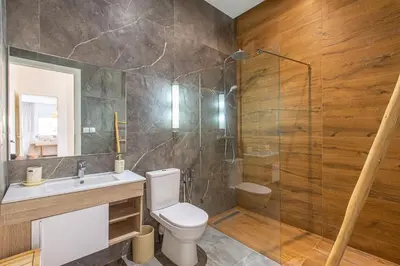 a bathroom with a toilet and a shower and a sink at Villa Safiya, Piscine Chauffée & jeux in Marrakech