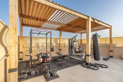 a gym with exercise equipment in a building at Villa Safiya, Piscine Chauffée & jeux in Marrakech
