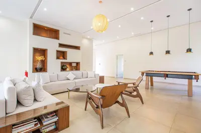 a living room with a couch and a pool table at Villa Safiya, Piscine Chauffée & jeux in Marrakech