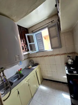a small kitchen with a sink and a window at light stay in Marrakech