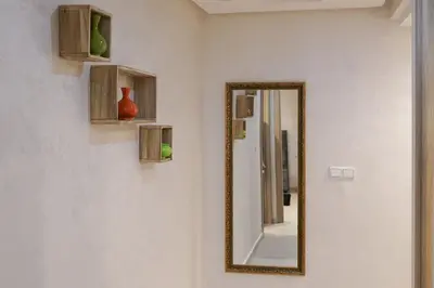 a mirror on a wall next to a bathroom at Apartment for rent ,Duplex in Marrakech