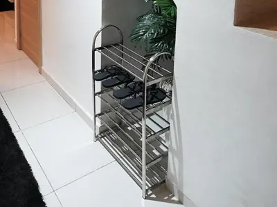 a metal rack with shoes in a hallway at Apartment for rent ,Duplex in Marrakech