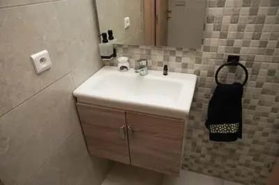 a bathroom with a white sink and a mirror at Apartment for rent ,Duplex in Marrakech