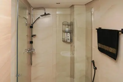 a shower with a glass door and a towel at Apartment for rent ,Duplex in Marrakech