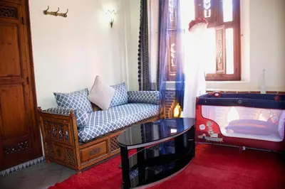 a living room with a couch and a table at Riad-style villa with a private pool in Marrakech