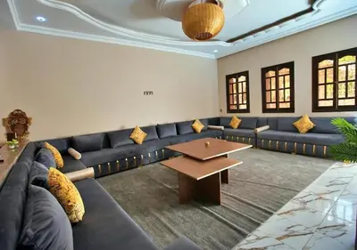 a living room with a blue couch and a table at cozy villa in Marrakech