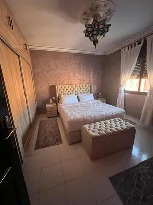 a bedroom with a bed and a couch in it at Marrakech gulize in Marrakech