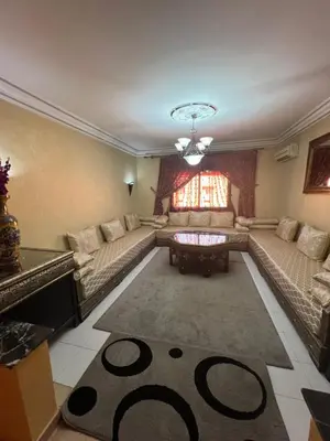 a living room with couches and a table and a rug at Marrakech gulize in Marrakech