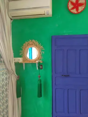 a room with a blue door and a green wall at Riad Dar Medina Land in Marrakech