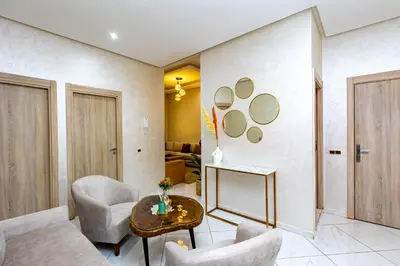 a living room with two chairs and a table at Elegant and Modern Apartment, Calm Cosy and Central in Marrakech