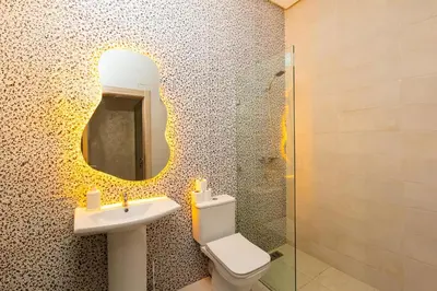 a bathroom with a sink and a toilet and a mirror at Elegant and Modern Apartment, Calm Cosy and Central in Marrakech