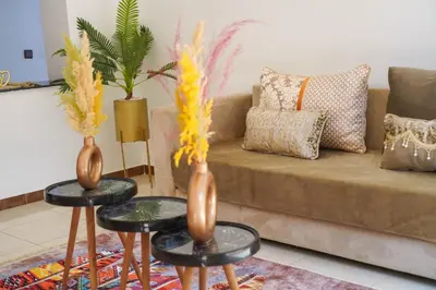 a living room with two vases on tables and a couch at Marrakesh Villa 1 in Marrakech