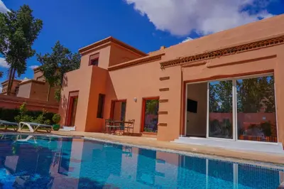 a villa with a swimming pool and a house at Marrakesh Villa 1 in Marrakech